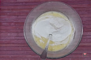 La foto raffigurante la farina e il lievito aggiunti nelle uova pr a base di uova per la preparazione dei Pancake red velvet
