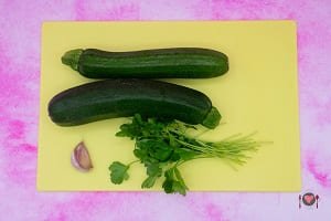 La foto raffigurante le zucchine, l'aglio il prezzemolo e la menta per la preparazione della torta salata zucchine e gamberetti