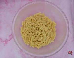 La foto raffigurante la pasta condita con un filo di olio per la preparazione della Pasta fredda con zucchine e gamberi