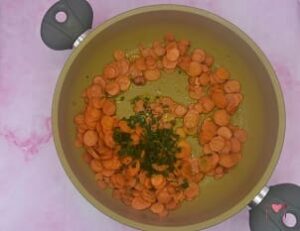 La foto raffigurante le carote regolate di sale e pepe, dove viene aggiunto il prezzemolo, per la preparazione delle carote in padella